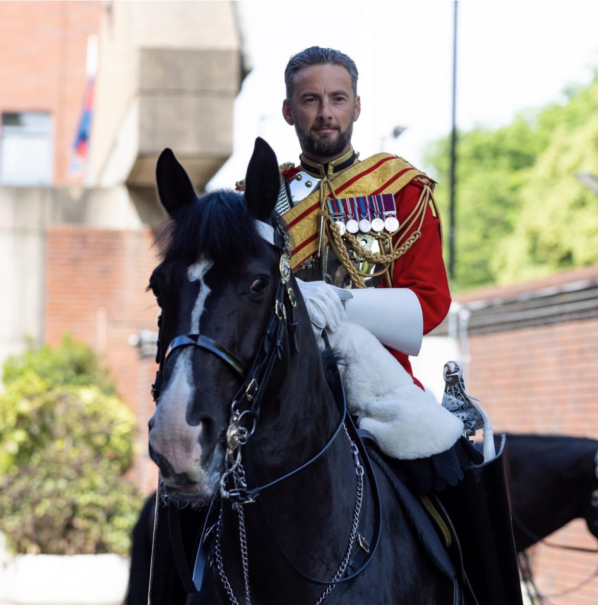 Tim Baker, founder of Cavalry Auto Locksmiths, mounted in Household Cavalry uniform